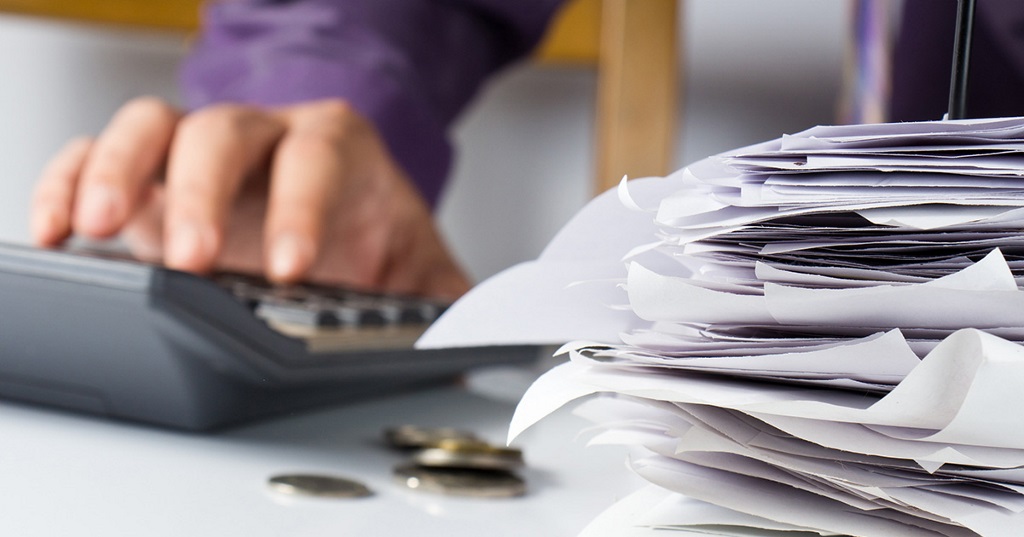 Man calculating savings of document management